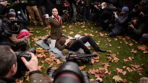Demonstrators take part in a mass "face-sitting protest" outside the Houses of Parliament in central London.