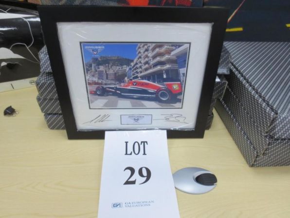 A signed photo of Jules Bianchi driving in the Monaco Grand Prix lends a poignant note to the auction. The French racer claimed the team's first points in Monaco this season but remains in hospital with severe head injuries after a crash at the Japanese Grand Prix in October.
