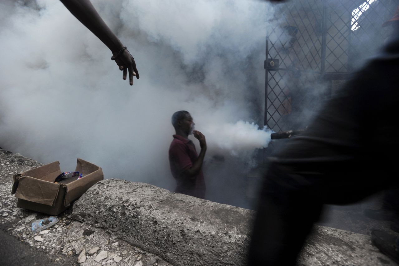 Workers from Haiti's Ministry of Public Health and Population spray chemicals to exterminate mosquitoes. Mosquito control is the main strategy used to prevent further spread of disease.