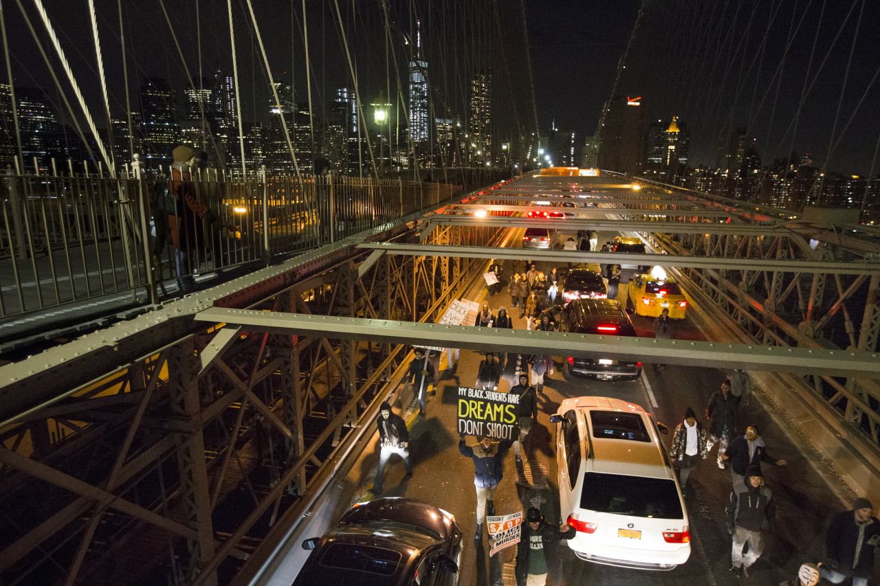 Demonstrators march over the inbound lane of the Brooklyn Bridge in New York on December 13.