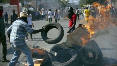 Demonstrators burn tires during anti-government protests in Port-au-Prince on December 13.
