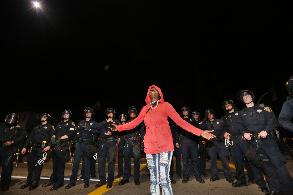 Mikela Mosley speaks out in front of a line of police during a demonstration on Saturday, December 13, in Oakland, California.