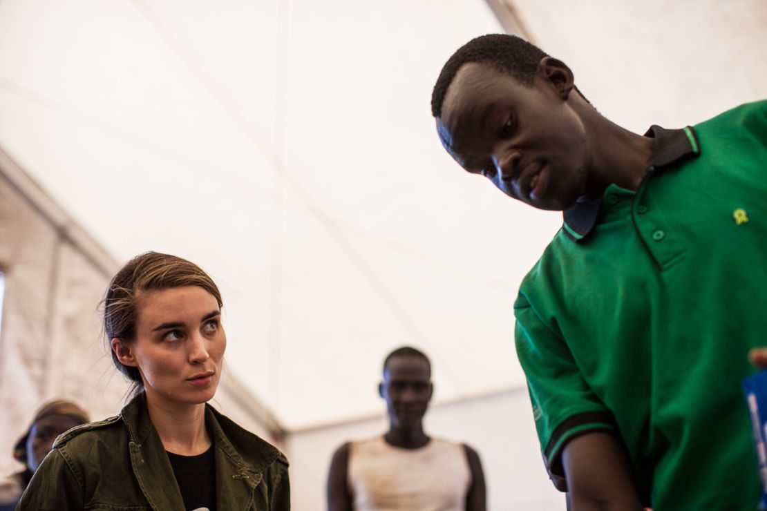 Rooney Mara listens as an Oxfam worker explains food distribution in South Sudan.