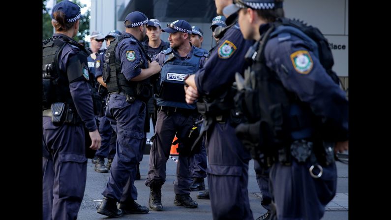 Police gather near the cafe on December 15.