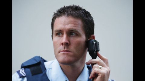 A police officer listens to a radio on December 15.