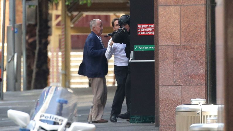 Two hostages make it to safety outside the cafe on December 15.