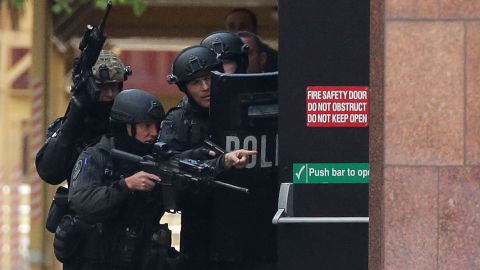 Armed police are seen outside the cafe on December 15.