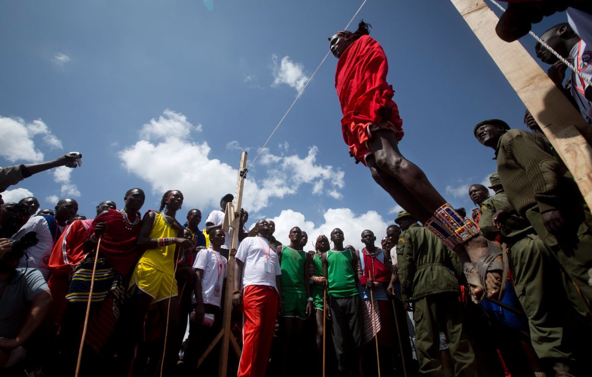 DECEMBER 15 - SIDAI OLENG WILDLIFE SANCTUARY, KENYA: A Maasai warrior competes in the high jump, in which athletes must touch a fixed line with the top of their heads, at the annual <a href="http://cnn.com/2014/12/05/africa/gallery/maasai-olympics/">Maasai Olympics</a> near Mount Kilimanjaro. Maasai men and women from the Amboseli and Tsavo region compete for medals and prizes in the event which aims to replace lion hunting as the traditional warrior activity. 