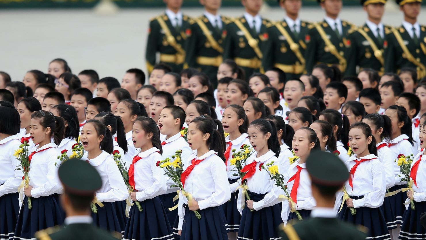 Chinese children sing the national anthem near the Monument to the People's Heroes in Beijing on Sept. 30.