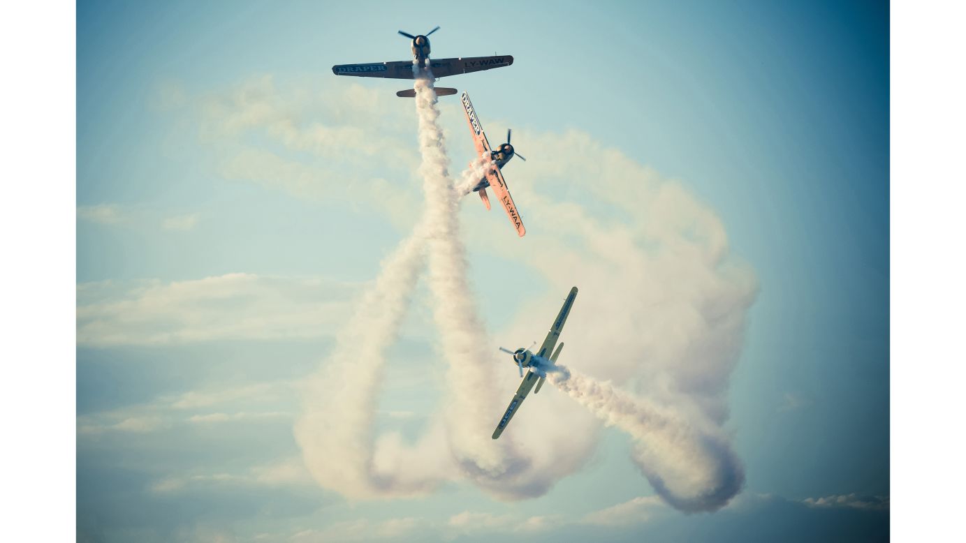 <strong>"Dog Fight," by Cioplea Vlad</strong><br /><br />Cioplea Vlad's dramatic image shows aerial acrobatics performed by pilots of YAK stunt planes at a Romanian air show.<br /><br />"This is exactly the moment when Romanian YAK Team is breaking the formation just in front of the public at Bucharest International Air Show," says Vlad. "At that moment they look just like they are hunting each other."
