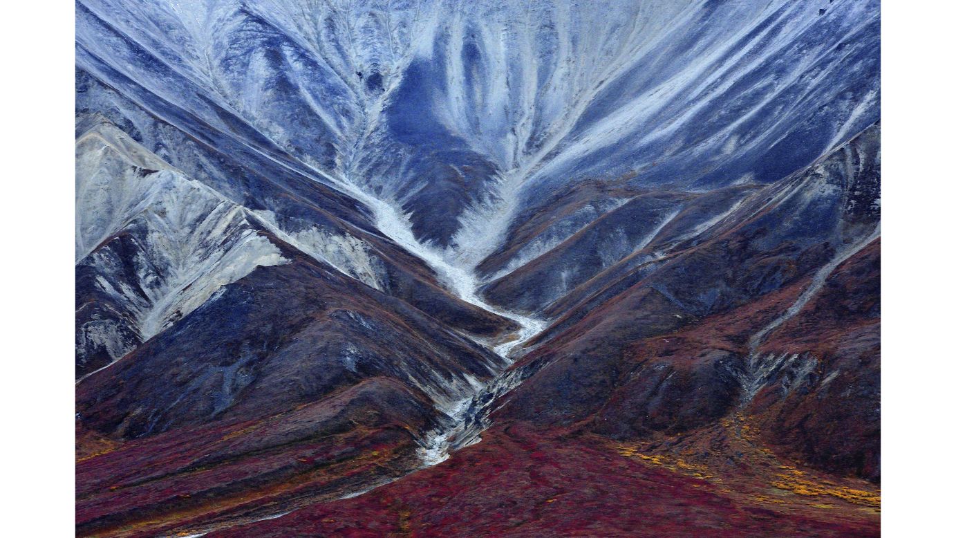 <strong>"The trace of an ancient glacier" by Miquel Artus Illana</strong><br /><br />Spanish photographer Miquel Artus Illana explores Alaska with his image, "The trace of an ancient glacier." The photo shows Denali National Park, where a rough road bisects six million acres of wilderness. <br /><br />"Travelers along it see the relatively low-elevation taiga forest give way to high alpine tundra and snowy mountains, culminating in North America's tallest peak Mount McKinley," says Artus.<br /><br />"What used to be glaciers are now white and blue rocks that contrast with red, yellow, orange and green tundra of this vast natural paradise. The image is taken in autumn when the colors multiply and make the landscape truly remarkable."