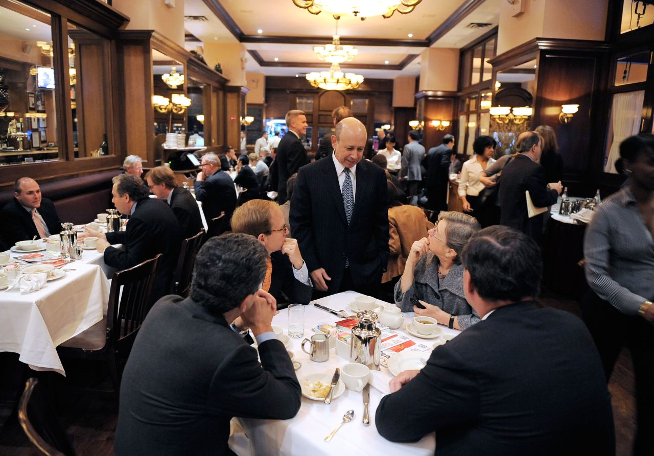 In New York, financiers such as Lloyd Blankfein (standing), chairman and CEO of Goldman Sachs, high roll at places like Bobby Van's Steakhouse and 3 Guys Restaurant.