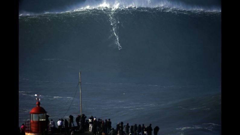 A surfer rides a massive wave in Nazare, Portugal, on Thursday, December 11.