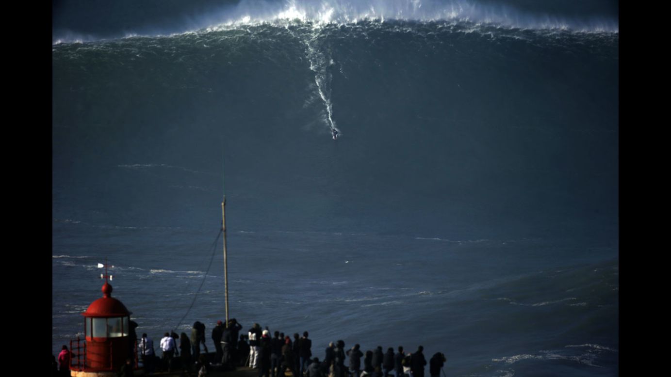 A surfer rides a massive wave in Nazare, Portugal, on Thursday, December 11.