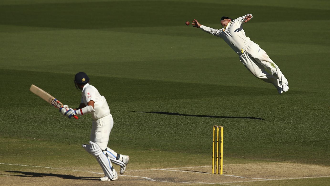 Australian cricket player David Warner dives for the ball Saturday, December 13, while playing a Test match against India in Adelaide, Australia. Australia won the match by 48 runs.