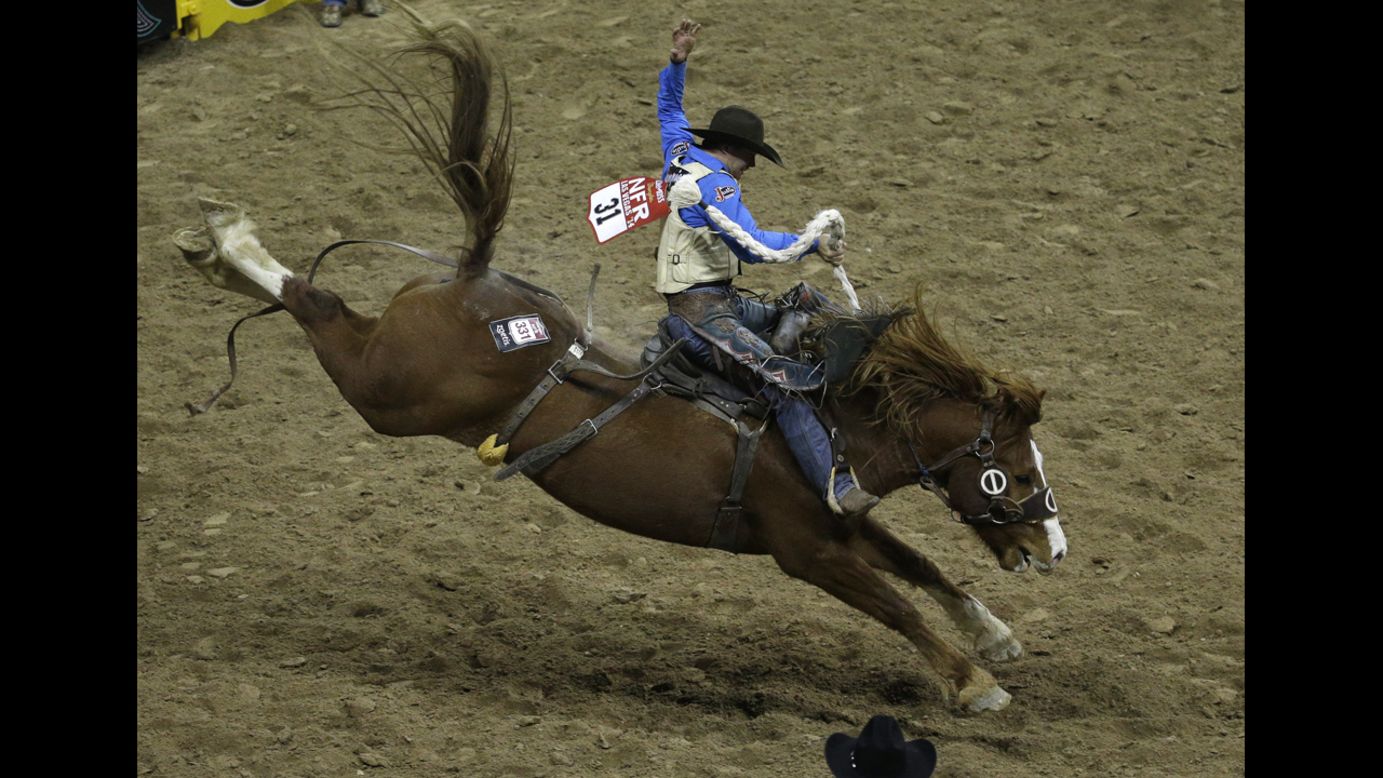 Heith DeMoss rides a bronco Thursday, December 11, as he competes in the National Finals Rodeo in Las Vegas. He finished first in the saddle bronc event.