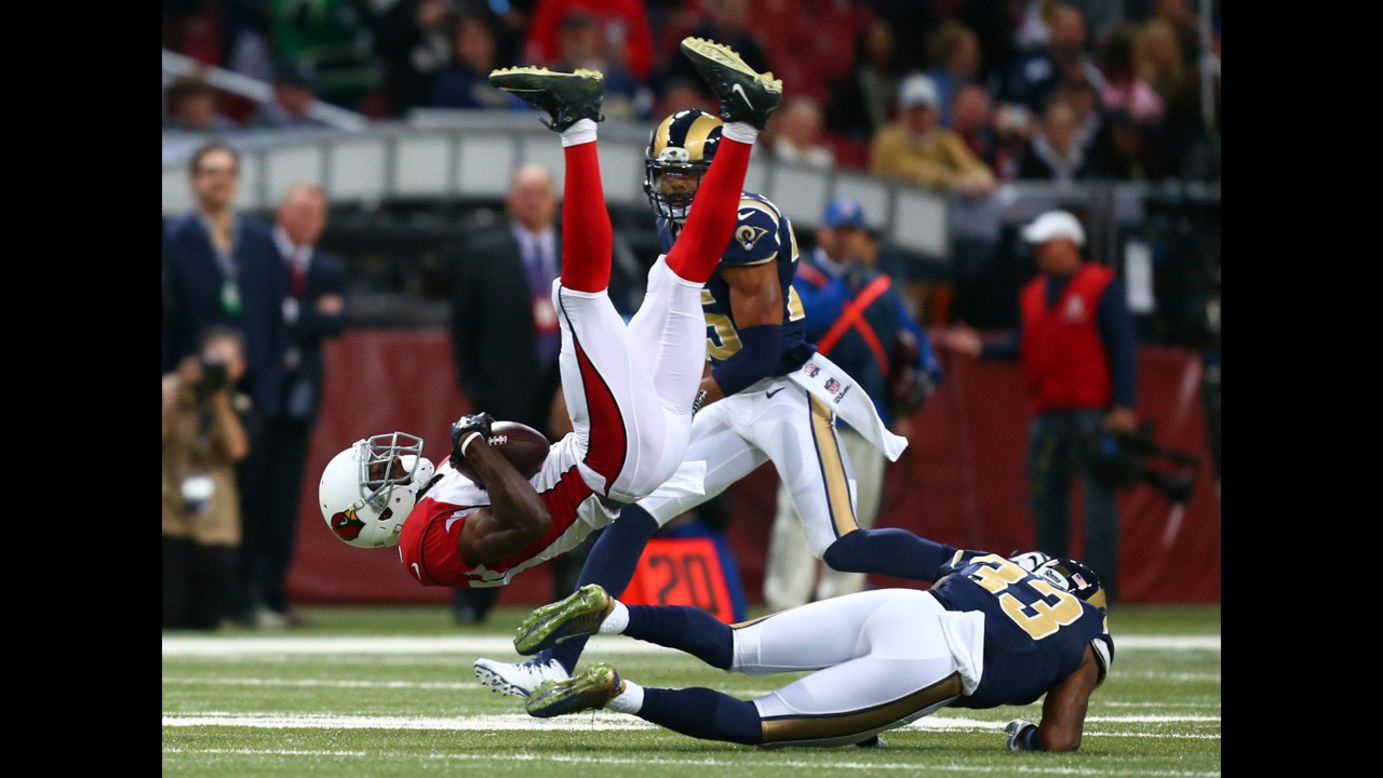 Arizona Cardinals wide receiver Jaron Brown is tackled by St. Louis Rams cornerback E.J. Gaines, right, during an NFL game played Thursday, December 11, in St. Louis. Arizona won 12-6 to clinch a playoff spot.