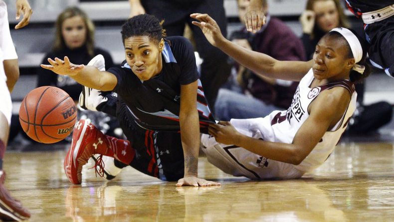 Louisiana Tech guard Chrisstasia Walter reaches for a loose ball after colliding with Mississippi State guard Morgan William during a game played Thursday, December 11, in Starkville, Mississippi.
