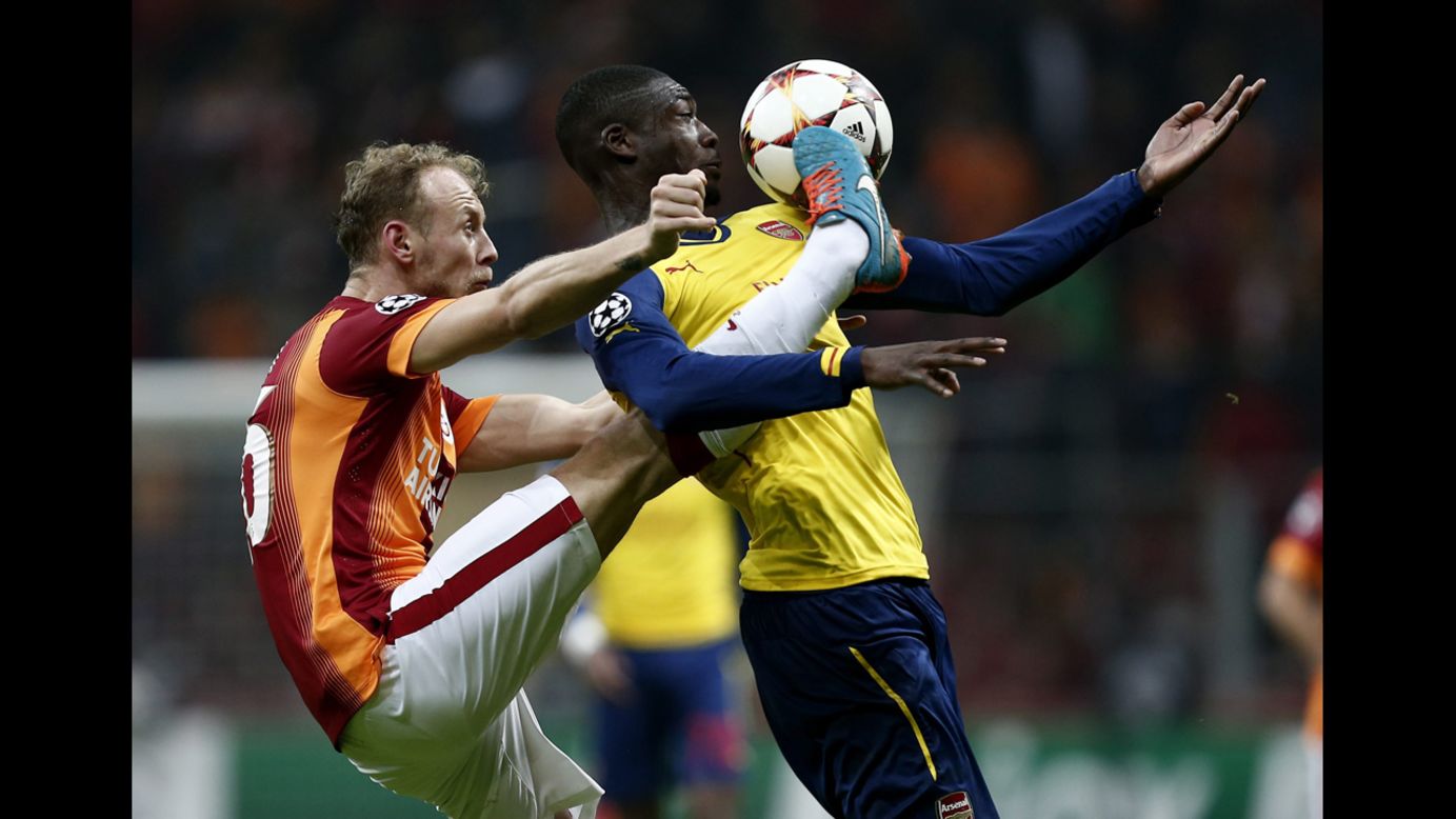 Galatasaray's Semih Kaya kicks a ball near the face of Arsenal's Yaya Sanogo during a UEFA Champions League match Tuesday, December 9, in Istanbul.