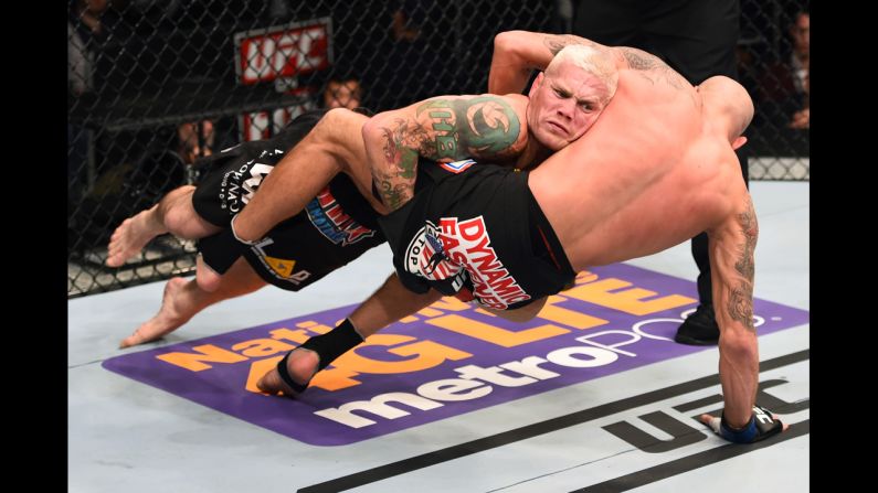 Joe Riggs takes down Ben Saunders during the first round of their welterweight bout Saturday, December 13, at UFC Fight Night in Phoenix. But Riggs hurt his neck on the slam and immediately tapped out.