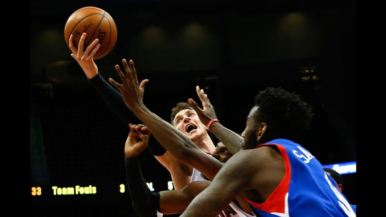 Mike Muscala of the Atlanta Hawks grabs a rebound while playing Philadelphia on Wednesday, December 10, in Atlanta.