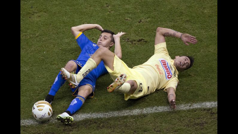 Jose Torres of Tigres, left, competes with Club America's Rubens Sambueza during the final of the Mexican league's Apertura tournament Sunday, December 14, in Mexico City. Club America defeated Tigres 3-1 over two legs.