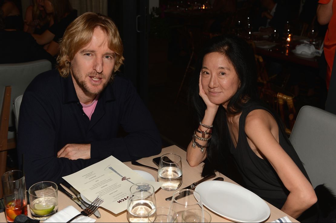 Owen Wilson and designer Vera Wang have put up with photographers while eating at The Dutch in Miami.