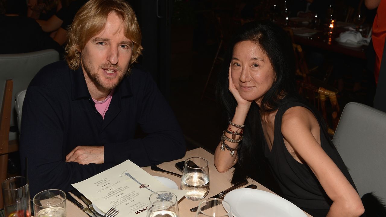 Owen Wilson and designer Vera Wang have put up with photographers while eating at The Dutch in Miami.