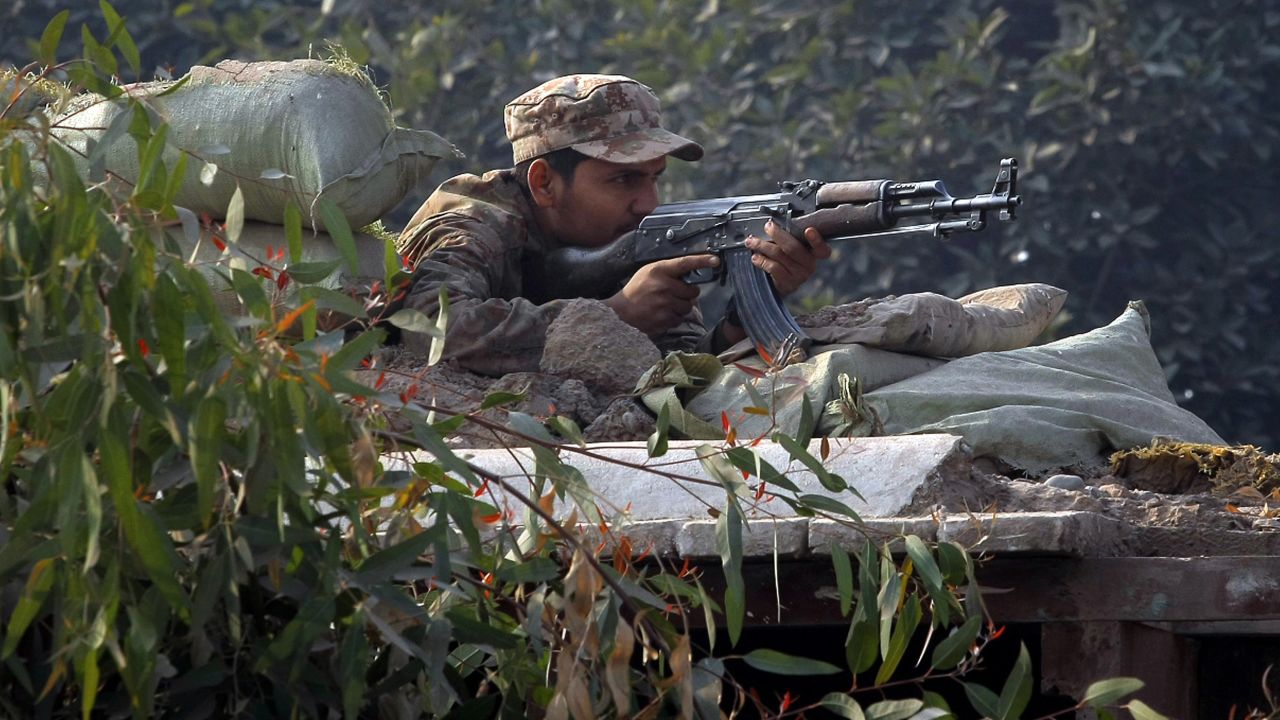 A Pakistani soldier takes position on a bunker close to the besieged school.