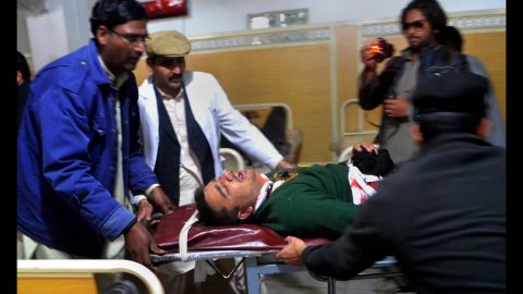 Hospital staff transport an injured student in Peshawar.