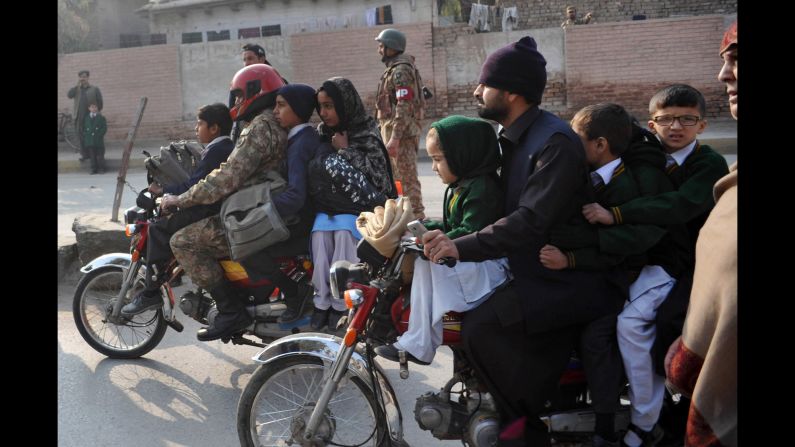 Parents leave with their children after <a href="http://www.cnn.com/2014/12/16/asia/gallery/taliban-attack-peshawar-school/index.html" target="_blank">a school in Peshawar, Pakistan, was attacked</a> on Tuesday, December 16. Several members of the Pakistani Taliban stormed the school, killing more than 140 people, mostly children. More than 100 people were injured.