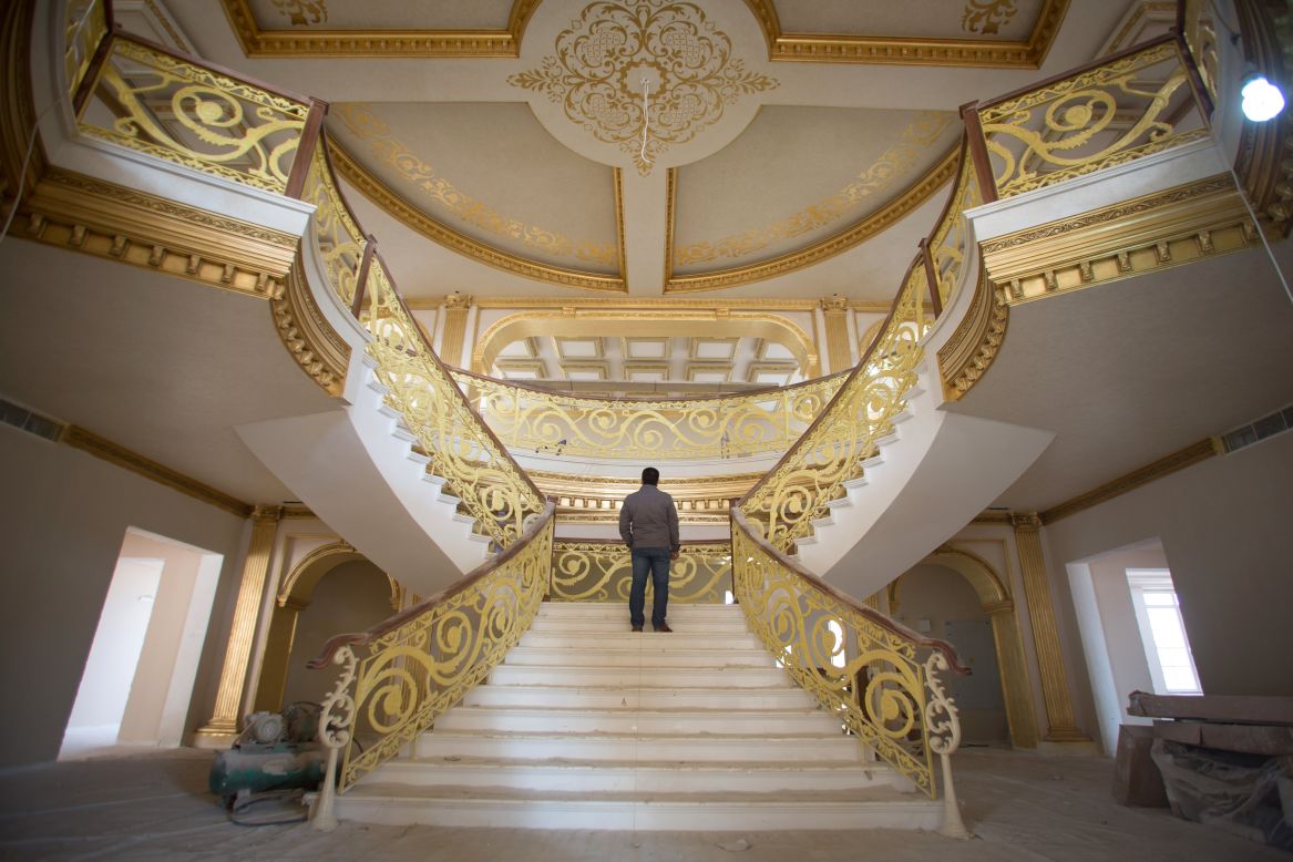 DECEMBER 16 - IRBIL, IRAQ: A construction worker walks up the staircase inside a $20 million replica of the White House being built inside Dream City. The exclusive residential suburb is one of several<a href="http://cnn.com/2014/01/07/business/can-black-gold-fuel-luxury-iraqi/"> high value areas developed in the Kurdish capital </a>since 2003, complete with their own mosque, shopping areas and schools. 