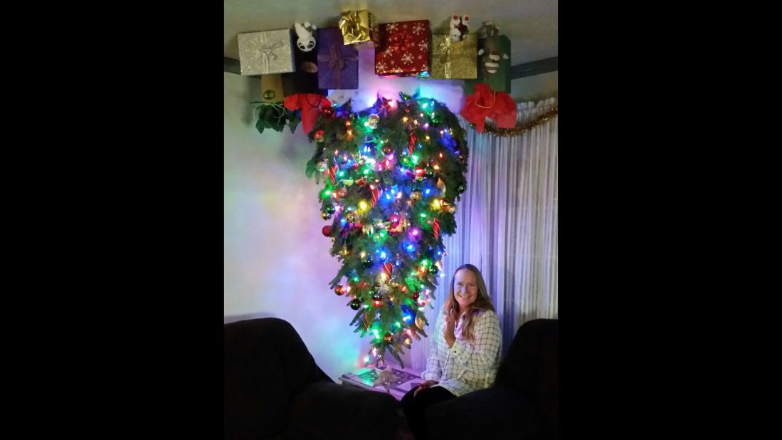 <a href="http://ireport.cnn.com/docs/DOC-1196629">Sherri Aguilar</a> attaches her inverted Christmas tree to the ceiling with eye bolts and uses a staple gun to put up the gift bags and presents.