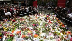 SYDNEY, AUSTRALIA - DECEMBER 16: Flowers are left as a sign of respect at Martin Place on December 16, 2014 in Sydney, Australia. The siege in Sydney's Lindt Cafe in Martin Place is over after 16 hours. Police raided the cafe just after 2am AEDT on Tuesday morning. Three people have been confirmed killed, two hostages and the gunman. (Photo by Mark Metcalfe/Getty Images)