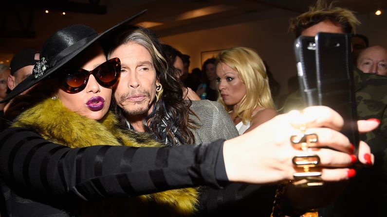 Model Amber Rose takes a selfie with Aerosmith frontman Steven Tyler as they attend the opening of a Rolling Stones photo exhibit Saturday, December 13, in Los Angeles. "It's Just A Shot Away: The Rolling Stones In Photographs" <a href="http://www.taschen.com/pages/en/catalogue/bundles/51973.its_just_a_shot_away_the_rolling_stones_in_photographs.5.htm" target="_blank" target="_blank">will be on display</a> until January 31 at the Taschen Gallery.