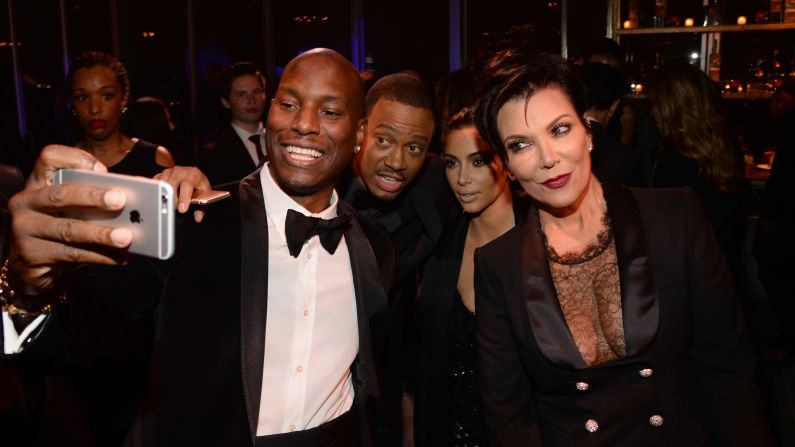 From left, actor Tyrese Gibson, actor Terrence J, television personality Kim Kardashian and Kardashian's mother, Kris Jenner, take a selfie at the Diamond Ball charity event Thursday, December 11, in Beverly Hills, California.
