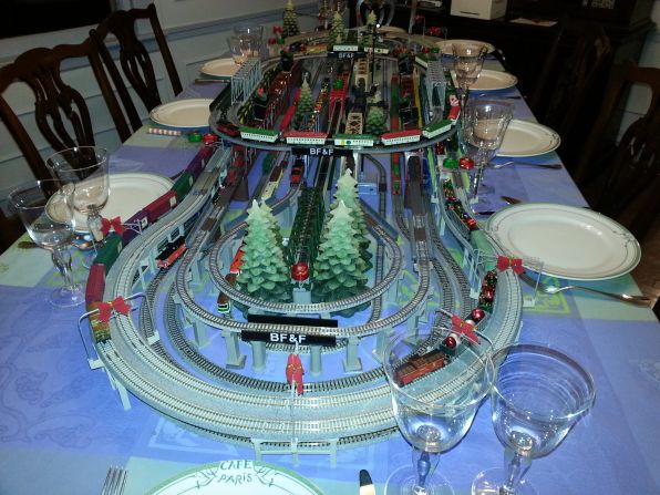 Every Christmas Eve, Maury Fisher unveils a new model train display on the dinner table to delight his grandchildren.