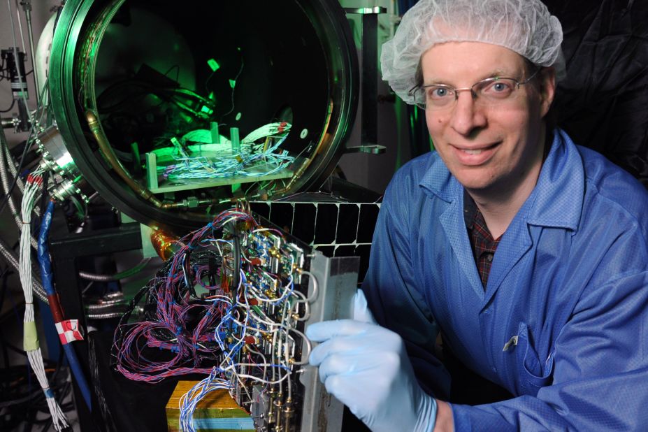Dr Paul Jaffe of the US Naval Research Laboratory holds a module he designed for space solar power in front of a customized vacuum chamber used to test it.  He says that while space-based solar power is likely decades away, many countries, in particular Japan, are still pursuing research into the power source. 