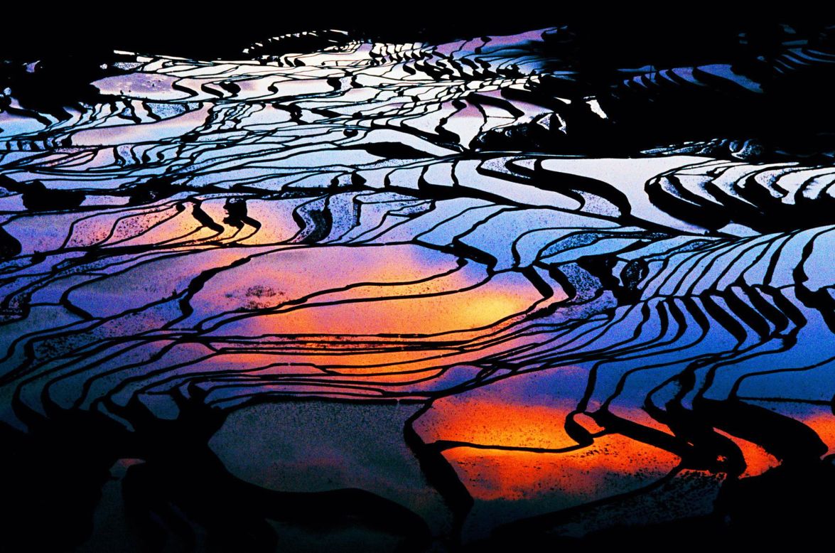 The mirrorlike pools of Yuanyang County's flooded rice terraces in China's Yunnan province allow for an array of intense visual effects. Ancestors of the Hani people crafted the terraces by hand more than 1,000 years ago to irrigate the red rice crop. The terraces change with the seasons; in the winter and spring, flooded paddies create reflective pools, which give way to rippling ribbons of bold green in the summer growing season.