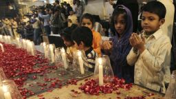 Pakistani children, chant prayers, during a candle light vigil for the victims of a Taliban attack on a school in Peshawar, organized by supporters of the Mutahida Qaumi Movement (MQM), in Karachi, Pakistan, Tuesday, Dec. 16, 2014. Taliban gunmen stormed a military-run school in the northwestern Pakistani city of Peshawar on Tuesday, killing more than 100, officials said, in the highest-profile militant attack to hit the troubled region in months. (AP Photo/Fareed Khan)