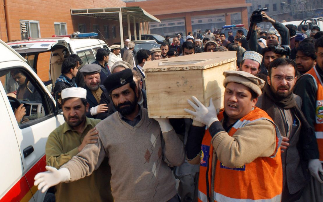 Volunteers move the coffin of a student who was killed in the December 2014 attack on a school in Peshawar.