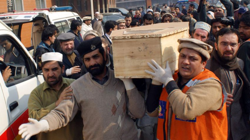 Caption:Pakistani volunteers move the coffin of a student from a hospital following an attack by Taliban gunmen on a school in Peshawar on December 16, 2014. Taliban insurgents killed at least 130 people, most of them children, after storming an army-run school in Pakistan December 16 in one of the country's bloodiest attacks in recent years. AFP PHOTO/ A MAJEED (Photo credit should read A Majeed/AFP/Getty Images)
