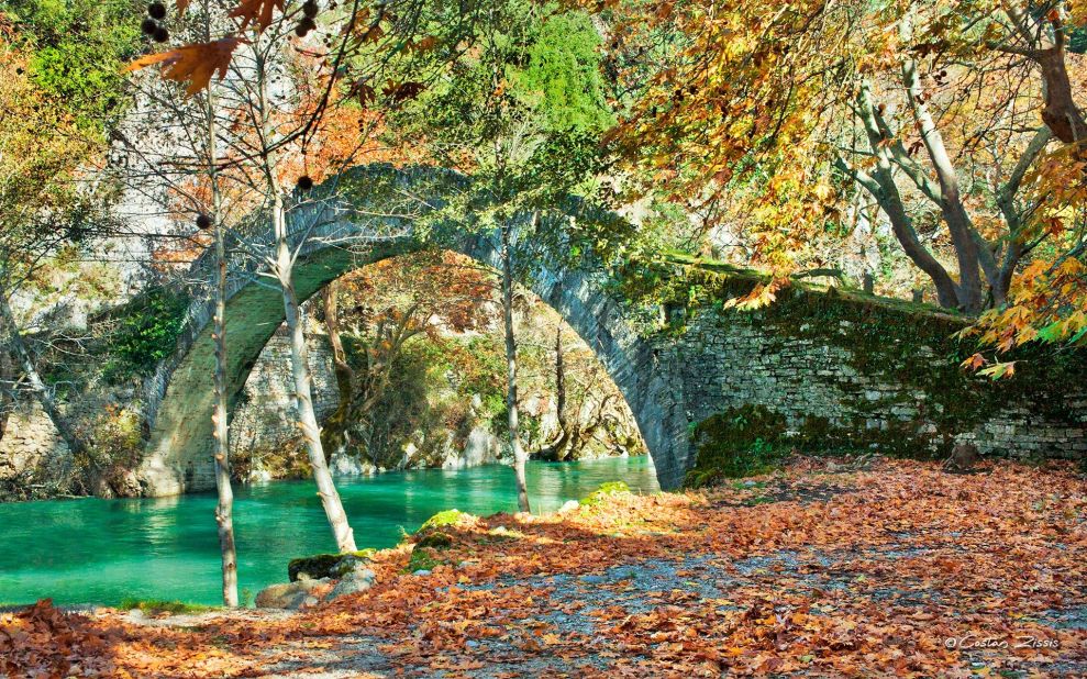 Scenic mountain roads and arched stone bridges connect villages filled with guesthouses and cafes around the Aristi Mountains.