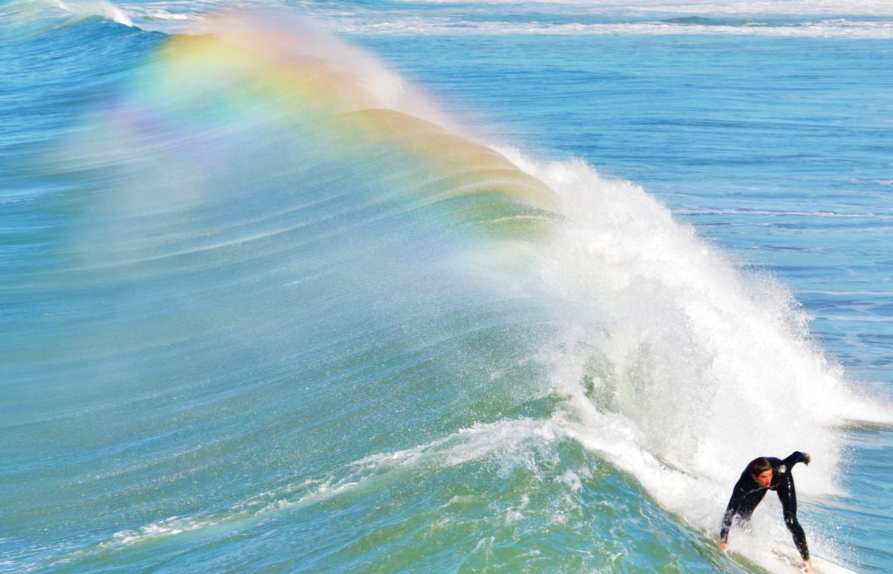 A surfer rides a wave off the coast of <a href="http://ireport.cnn.com/docs/DOC-1078219">San Diego, California</a>.