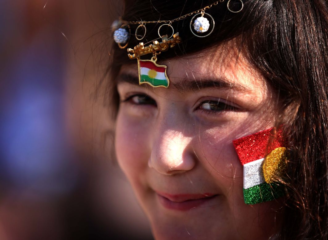 DECEMBER 17 - IRBIL, IRAQ: A young woman with the Kurdish flag decorating her face smiles as she takes part in celebrations for Flag Day in the capital of the autonomous Kurdish region.