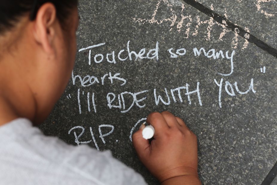 A message of condolence is written on the pavement at Martin Place, Sydney on Wednesday, December 17. #illridewithyou became a trending hashtag on Twitter during the siege, expressing solidarity with Australian Muslims in the wake of deadly siege at the Lindt Cafe in Sydney.