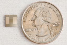 The tiny chip next to a U.S. quarter.