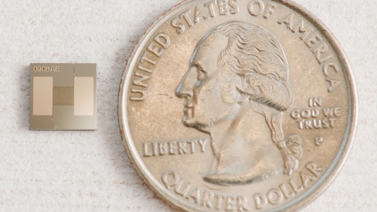The tiny chip next to a U.S. quarter.