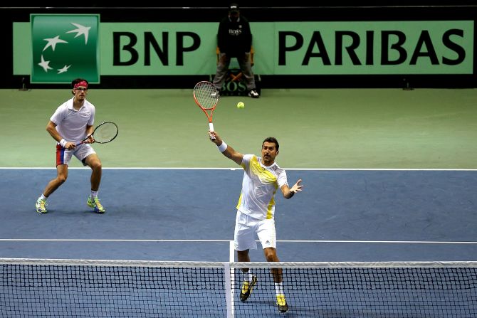 At 38, Nenad Zimonjic (center) has enjoyed a long and winning singles and doubles career, including Davis Cup victories for Serbia on home turf. 