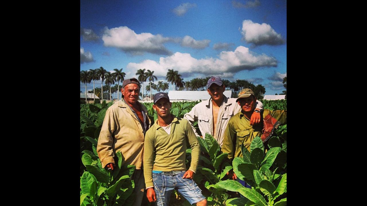 Tobacco workers take a break from picking leaves that will be dried and rolled into cigars, Oppmann says.